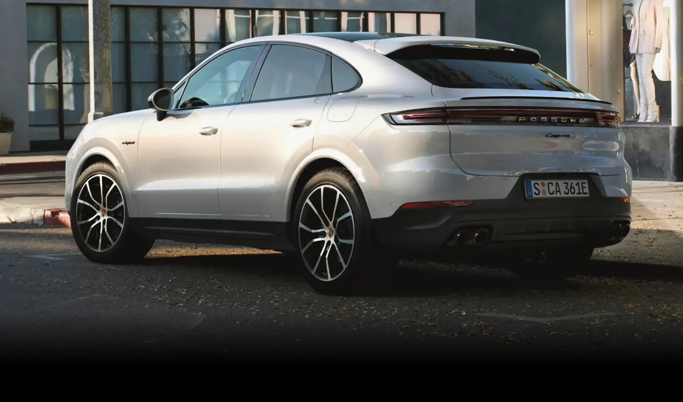 Vista lateral em ambiente urbano da família Porsche Cayenne E-Hybrid Coupé